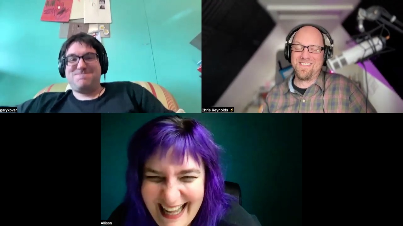 A screenshot from a video podcast episode featuring three hosts. In the top left, Gary is smiling, wearing headphones and a black t-shirt, seated in front of a light blue wall with a striped chair and various items pinned to a board behind him. In the top right, Chris, also wearing headphones, is grinning widely, dressed in a plaid shirt with a microphone in front and a dark, soundproofed room behind him. On the bottom, Allison is laughing, with vibrant purple hair, wearing headphones and a dark top, against a blurred background. The atmosphere is jovial and informal.